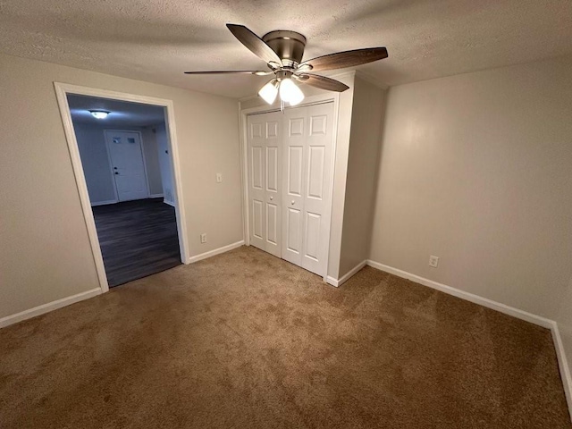 1095 S Burnt Hickory Rd, Douglasville, GA 30134 - unfurnished bedroom with carpet, a textured ceiling, a closet, baseboards, and a ceiling fan