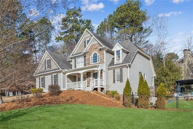 view of property with a porch and a front lawn