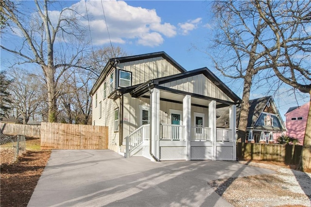 view of front of home featuring covered porch, fence, and board and batten siding