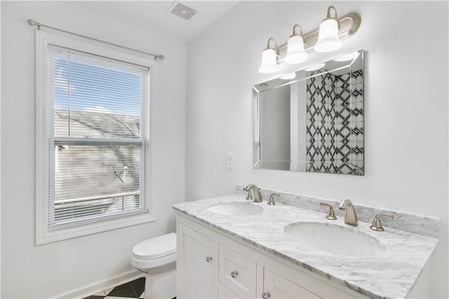 full bath with toilet, visible vents, a sink, and tile patterned floors