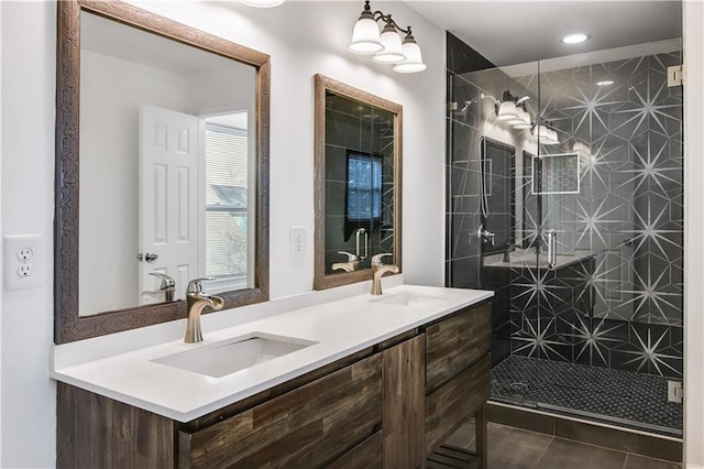 bathroom featuring a stall shower, tile patterned flooring, a sink, and double vanity