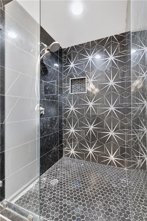 bathroom with tiled shower