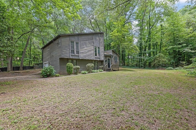 view of home's exterior with an attached garage and a lawn
