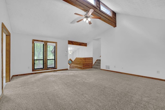 unfurnished living room with carpet flooring, a textured ceiling, stairs, baseboards, and ceiling fan