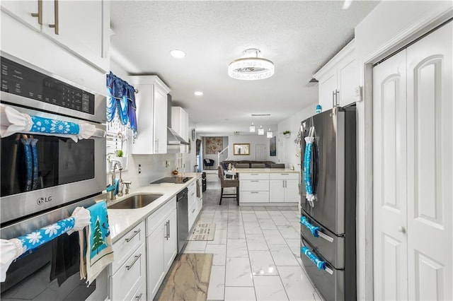 kitchen with marble finish floor, a sink, stainless steel appliances, white cabinets, and light countertops