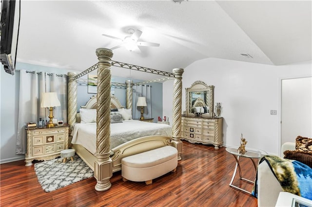 bedroom featuring a ceiling fan, wood finished floors, baseboards, lofted ceiling, and a textured ceiling