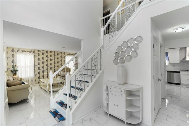 staircase with baseboards and marble finish floor