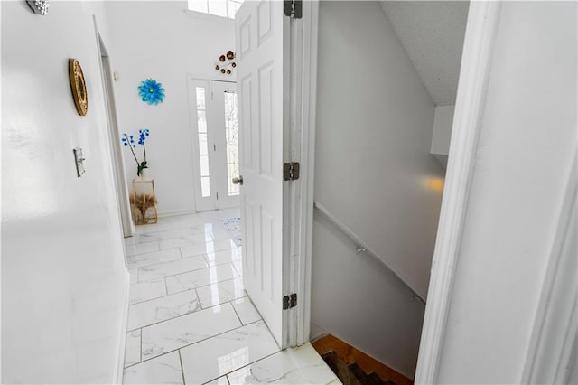 interior space featuring a textured ceiling and marble finish floor