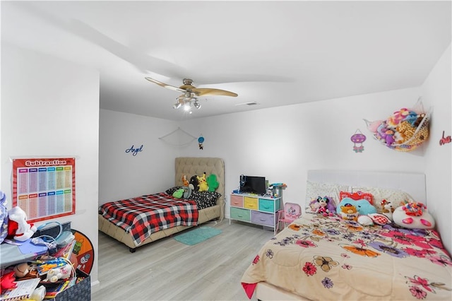 bedroom featuring visible vents, a ceiling fan, and light wood-type flooring