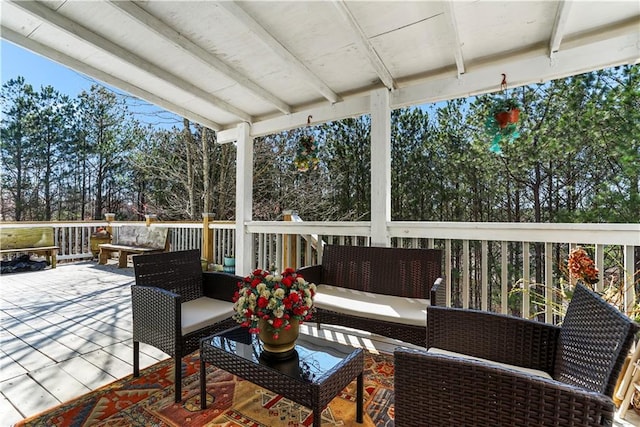 sunroom / solarium featuring beam ceiling and plenty of natural light