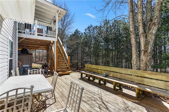 wooden deck with stairway and outdoor dining space