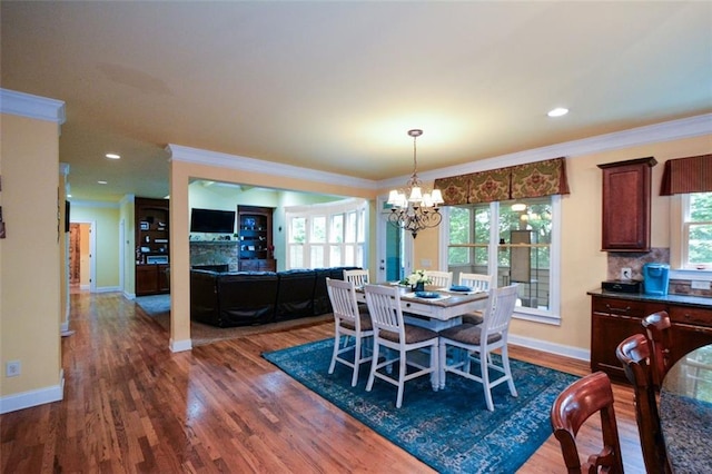 3423 Mulberry Lane Ct, Dacula, GA 30019 - dining space featuring a chandelier, ornamental molding, dark wood-type flooring, and recessed lighting