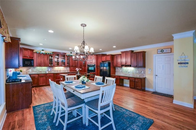 3423 Mulberry Lane Ct, Dacula, GA 30019 - dining room with crown molding, a chandelier, wood finished floors, and recessed lighting