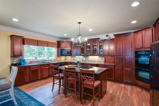 3423 Mulberry Lane Ct, Dacula, GA 30019 - kitchen featuring light wood-type flooring, a chandelier, a kitchen bar, recessed lighting, and ornamental molding