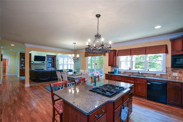 3423 Mulberry Lane Ct, Dacula, GA 30019 - kitchen featuring black appliances, a chandelier, dark wood-type flooring, a breakfast bar area, and ornamental molding