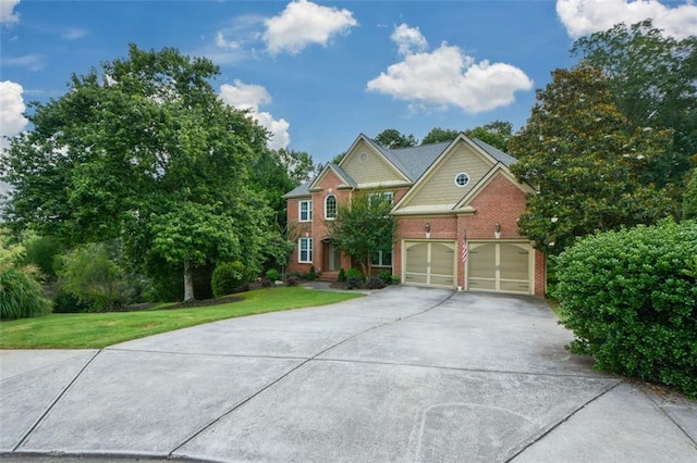 3423 Mulberry Lane Ct, Dacula, GA 30019 - view of front of house featuring concrete driveway, a garage, a front yard, and brick siding