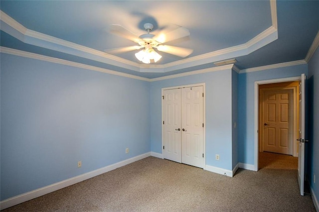 3423 Mulberry Lane Ct, Dacula, GA 30019 - unfurnished bedroom featuring a raised ceiling, carpet flooring, crown molding, a closet, and a ceiling fan
