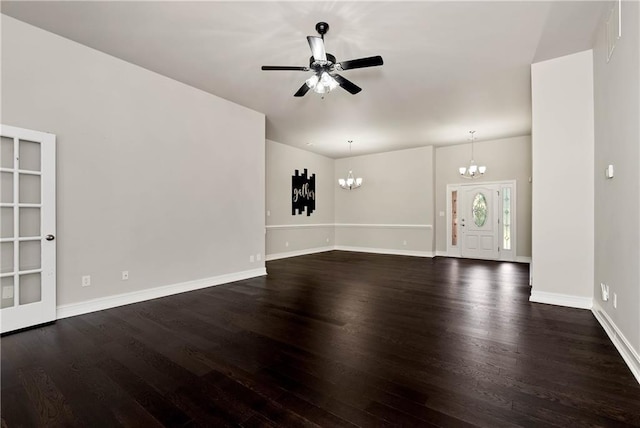 unfurnished living room featuring a chandelier, dark wood finished floors, a ceiling fan, and baseboards