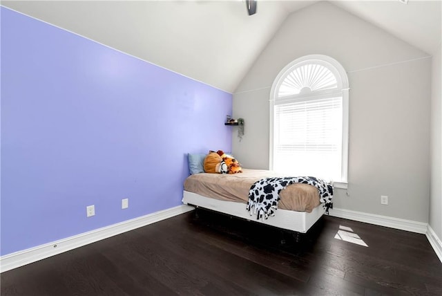 bedroom with multiple windows, vaulted ceiling, wood finished floors, baseboards, and a ceiling fan