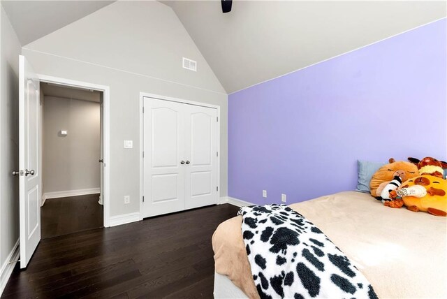bedroom with wood finished floors, baseboards, a closet, high vaulted ceiling, and ceiling fan