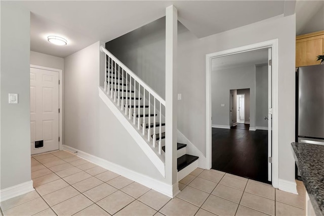 stairs with tile patterned flooring and baseboards
