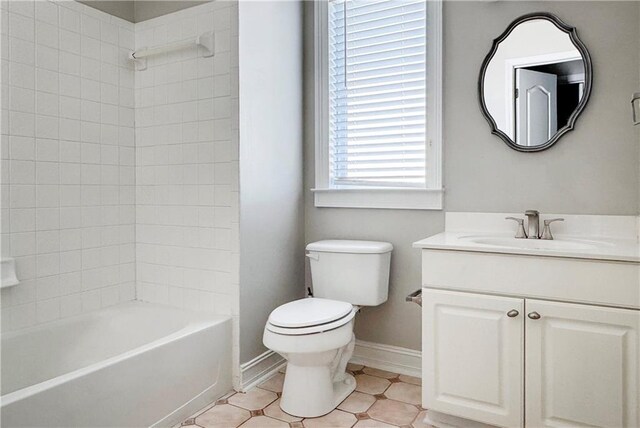 bathroom featuring baseboards, toilet, vanity, and shower / washtub combination