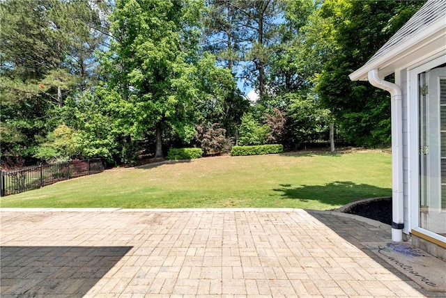 view of yard featuring a patio and view of scattered trees