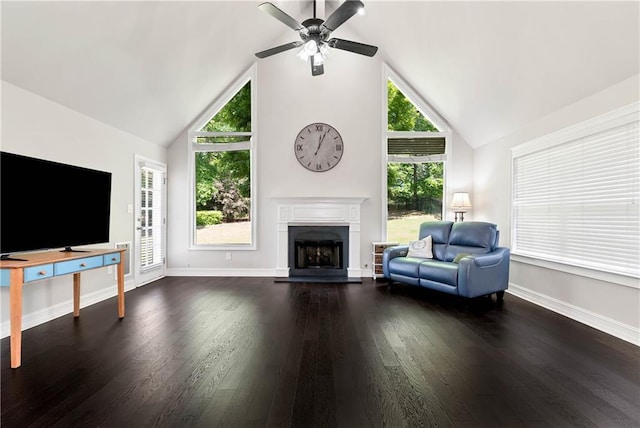 living room featuring a fireplace, a ceiling fan, wood finished floors, baseboards, and high vaulted ceiling