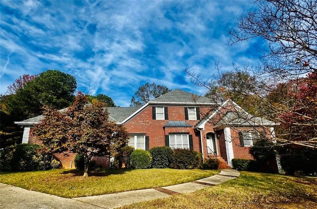 view of property featuring a front lawn