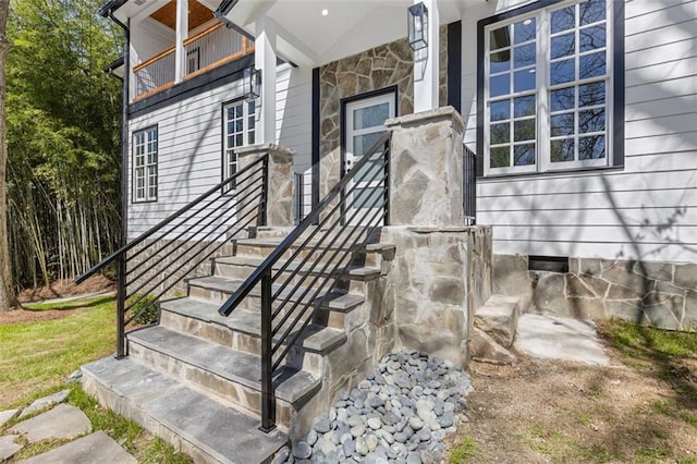 view of exterior entry with a balcony