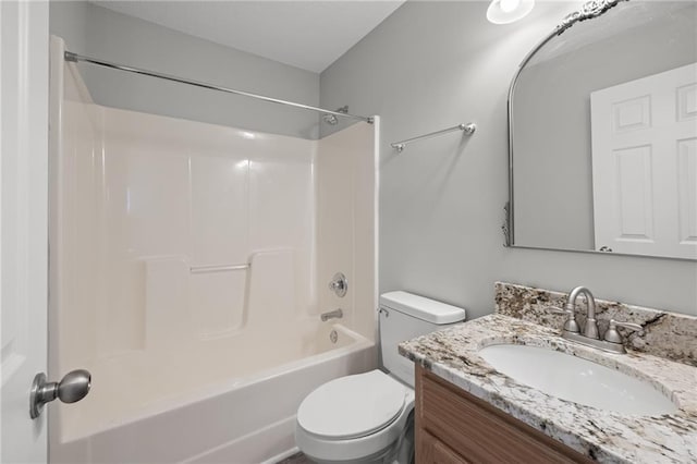 bathroom featuring vanity, shower / bathing tub combination, and toilet