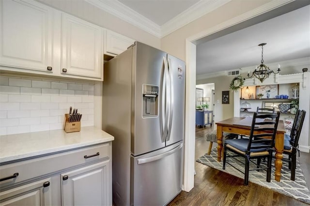 kitchen with white cabinetry, an inviting chandelier, dark hardwood / wood-style floors, stainless steel refrigerator with ice dispenser, and decorative light fixtures