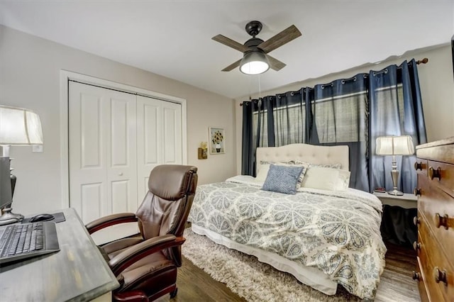 bedroom with dark hardwood / wood-style flooring, ceiling fan, and a closet