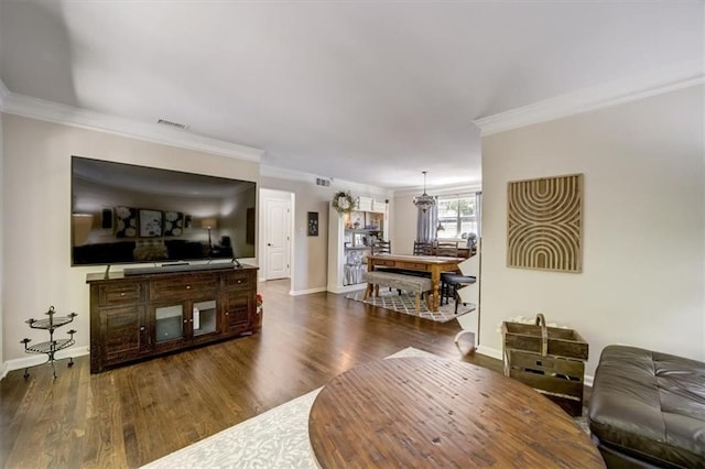 living room featuring dark hardwood / wood-style floors and ornamental molding