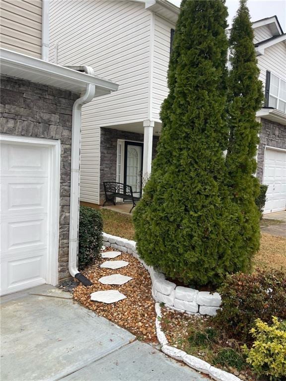 view of side of home featuring a garage