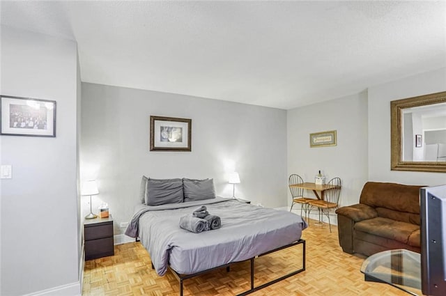 bedroom with light parquet floors