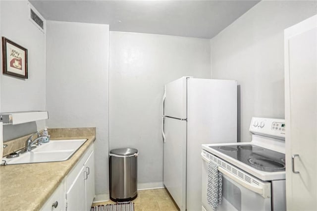 kitchen featuring sink, light tile patterned floors, white cabinets, and white appliances