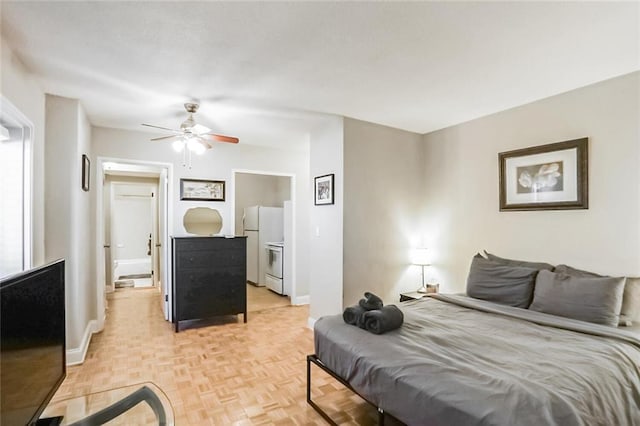 bedroom featuring white refrigerator, ceiling fan, and light parquet floors