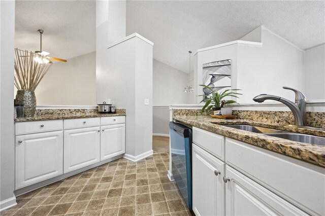 kitchen with dishwashing machine, a sink, dark stone counters, white cabinets, and a textured ceiling