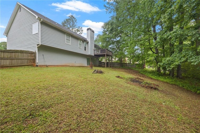 view of yard with a wooden deck and a fenced backyard