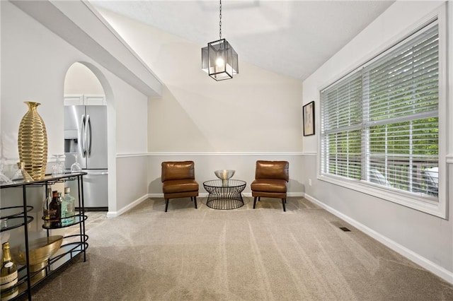 sitting room featuring baseboards, visible vents, carpet, and vaulted ceiling