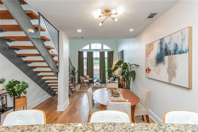 dining space with visible vents, stairs, wood finished floors, baseboards, and recessed lighting