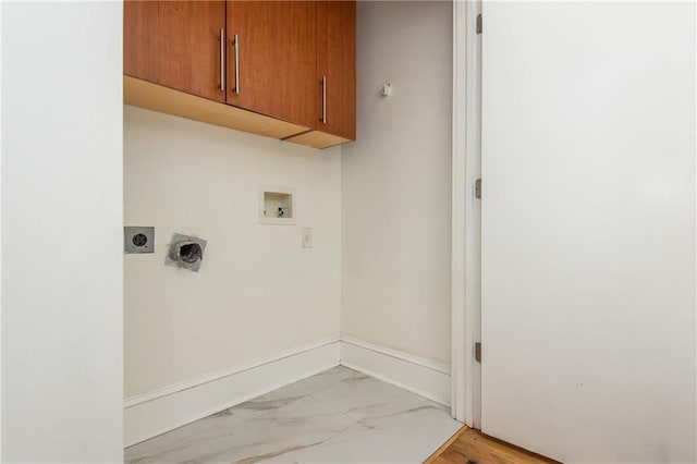 washroom featuring marble finish floor, baseboards, hookup for a washing machine, electric dryer hookup, and cabinet space
