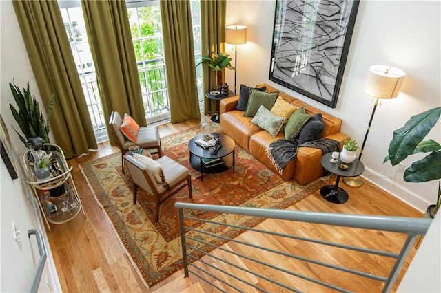living area featuring baseboards and wood finished floors