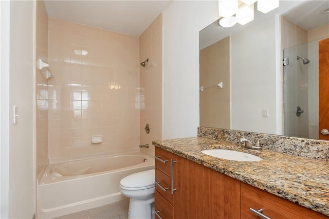 full bathroom with tile patterned floors, washtub / shower combination, vanity, and toilet