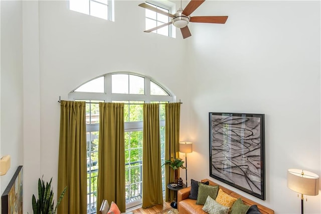 interior space with a high ceiling and a ceiling fan