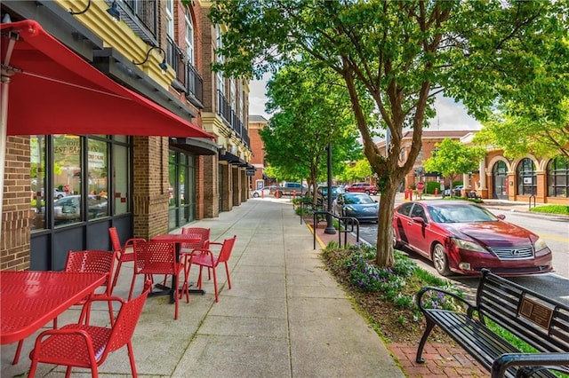 view of community featuring outdoor dining space