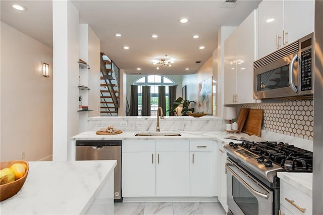 kitchen featuring a sink, tasteful backsplash, stainless steel appliances, and recessed lighting