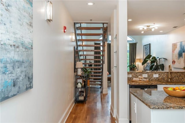 corridor with a sink, baseboards, recessed lighting, and wood finished floors