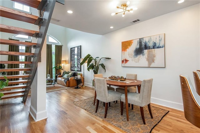 dining area featuring stairs, wood finished floors, and visible vents